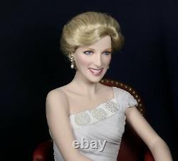 Franklin mint princess diana porcelain doll sitting in red chair