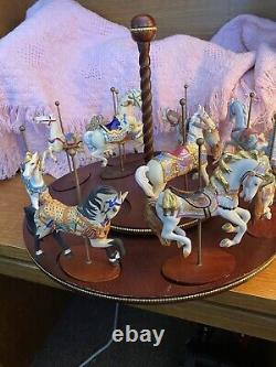 The Treasury Of Carousel Art With 10 Porcelain Figurines On A Wood Base